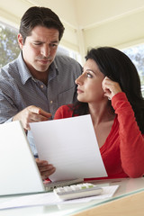 Hispanic Couple Working In  Home Office