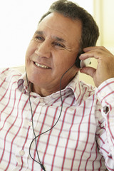 Obraz premium Senior Hispanic Man Wearing Headphones