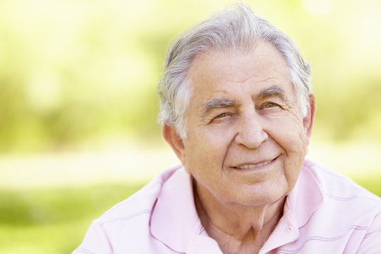 Senior Hispanic Man Relaxing In Park