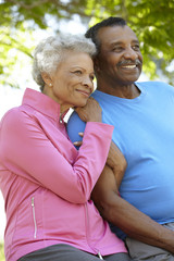 Portrait Of Senior African American Couple Wearing Running Clothing In Park