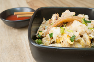 Fried Noodle with seafood and dip on wooden table - selective fo