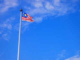 Malaysia flag waving on the wind with blue sky