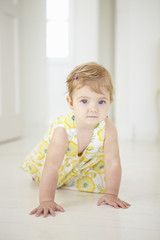 Young Girl Crawling On Floor In Bedroom