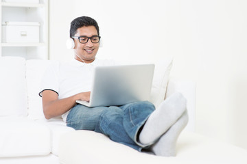 Indian guy listening to music