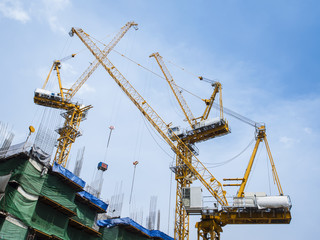 Fototapeta na wymiar Cranes work in construction site