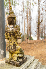 Respected angel statue with white pagoda background in Wat Phra