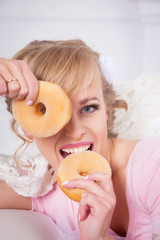 Portrait of attractive young charming woman with donuts