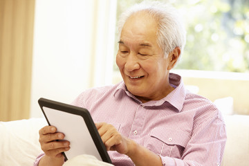 Senior Asian man using tablet