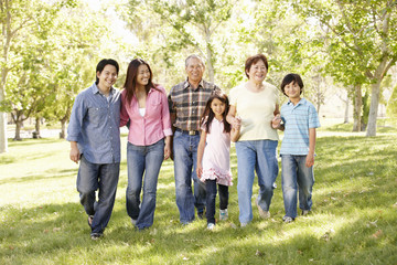 Obraz premium Multi-generation Asian family walking in park