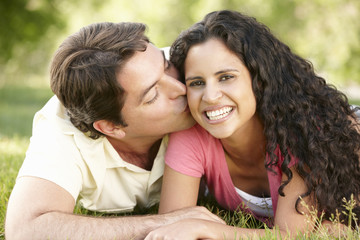Fototapeta premium Romantic Young Hispanic Couple Relaxing In Park