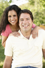 Fototapeta premium Romantic Young Hispanic Couple Relaxing In Park