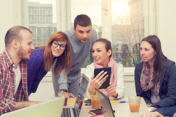 Young group of people discussing business plans.