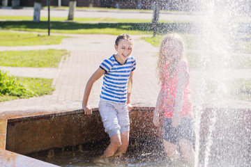 two happy girls at the fountain