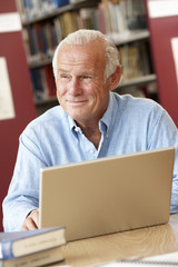 Fototapeta premium Mature student working in library