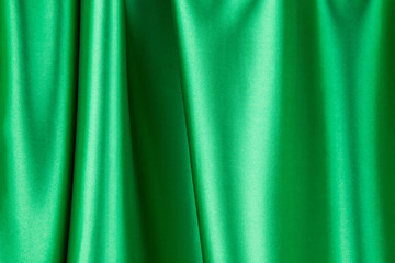 Green silk cloth with some soft folds.