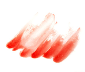 Orange lip gross brush stroke on white background