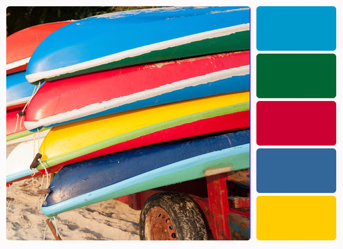 Colorful plastic boats on a rack ashore , colour palette swatche