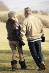 Mature couple on country walk in winter