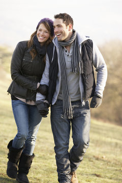 Couple On Romantic Country Walk In Winter