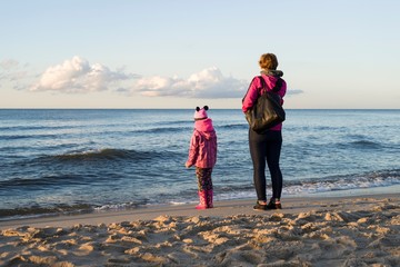 Mother with her doughter on sea beach