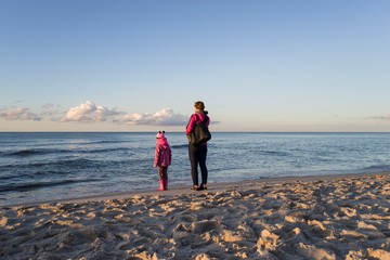 Mother with her doughter on sea beach