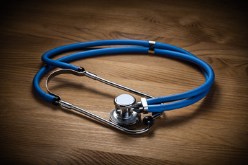 classical medical tool stethoscope on wooden board