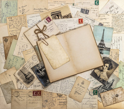 Open book, old letters and postcards. Travel memories scrapbook