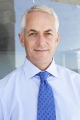 Mature Businessman Standing Outside Modern Office