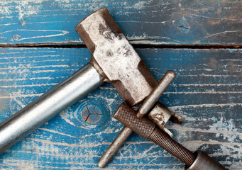 Hammer tool on wood background