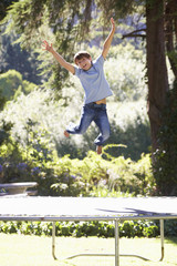 Young Boy Having Fun On Trampoline