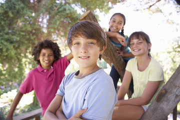 Group Of Children Hanging Out In Treehouse Together