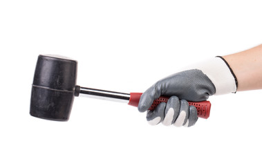 Man's hand in glove holds hammer.