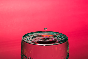 Drop of water with red background