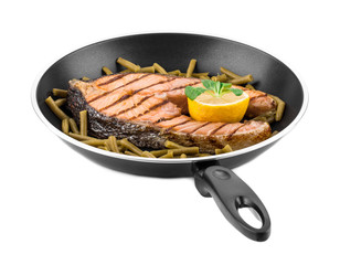 Frying pan with salmon steak.