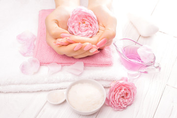 Fototapeta na wymiar french manicure with essential oils, rose flowers. spa