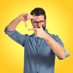 Young hipster man focusing with his fingers