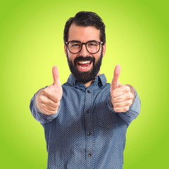 Young hipster man with thumb up