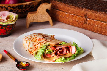 food pancake ham cheese lettuce and sauce on a plate still life