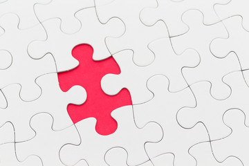 Jigsaw puzzle with missing piece over red background