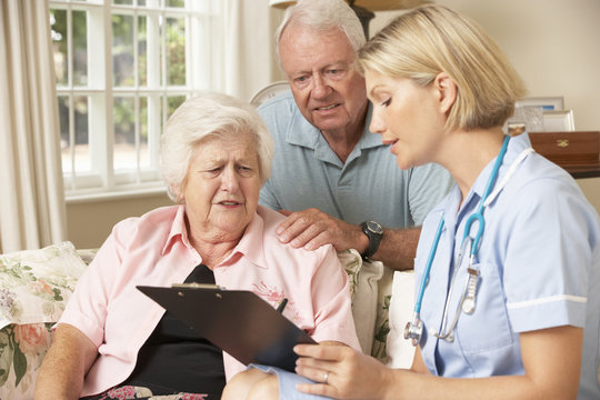 Retired Senior Woman Having Health Check With Nurse At Home