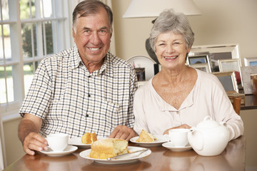 Retired Senior Couple Enjoying Afternoon Tea Together At Home