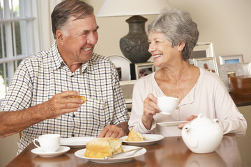 Retired Senior Couple Enjoying Afternoon Tea Together At Home