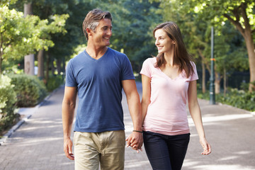 Romantic Couple Walking Through Summer Park