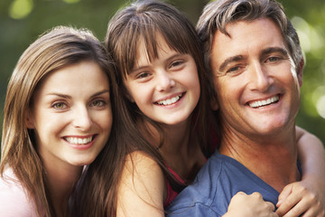 Fototapeta premium Dad Giving Daughter Piggyback On Family Walk