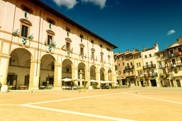 AREZZO, ITALY - MAY 12, 2015: Tourists enjoy Piazza Grande on a