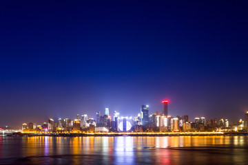 Fototapeta na wymiar illuminated skyline of chongqing at riverbank