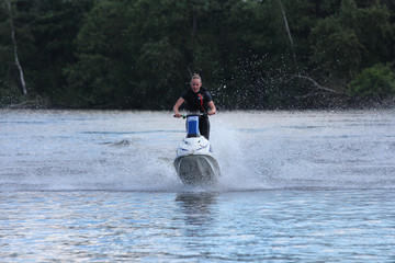 Naklejka premium Action Photo young woman on jet ski. 