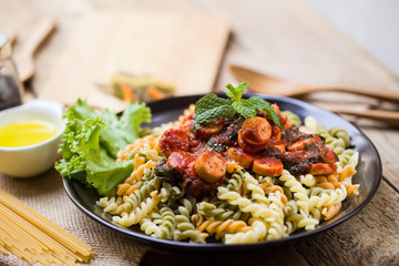 low angle view of a serving of Italian spaghetti on wood table