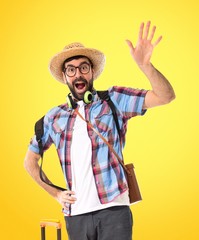 Tourist saluting over white background