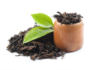 Black tea with green leaf isolated on white